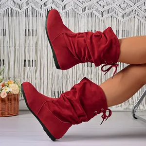 Red slouchy suede mid-calf boots for women with warm lining and back lacing detail.