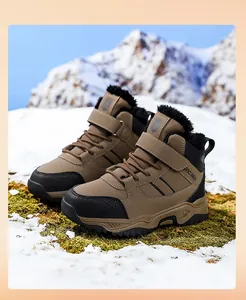 Detail view of brown boys' outdoor snow boots with warm faux fur lining and velcro strap.