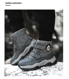 Close-up detail of grey children's winter snow boots with warm lining and straps.