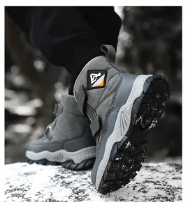 Detail view of children's grey snow boots with anti-slip lug sole in winter scenery.