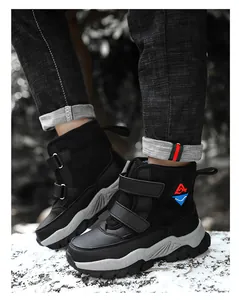 Detailed side view of children's black winter snow boots with warm lining and velcro straps