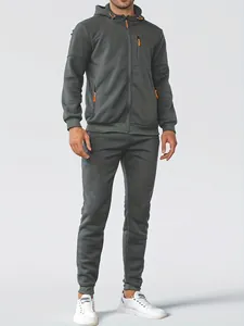 Detailed studio shot of a men's dark grey hooded zip-up hoodie and matching joggers