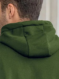 Close-up view showing the textured green hood of a men's casual hooded sweatshirt