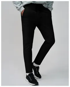 Close-up detail of men's black quick-dry breathable running pants worn by a model