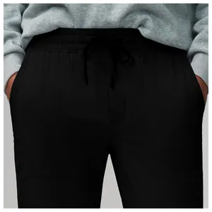 Close-up of men's quick-dry black sports pants with drawstring waist and pockets