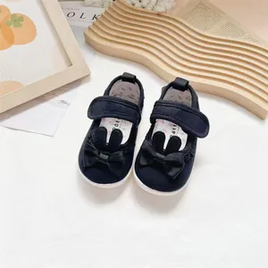 Detailed view of black toddler canvas shoes featuring cute bunny ears and a bow