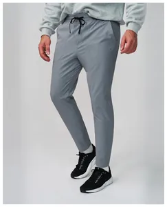 Detailed shot of men's grey quick-dry breathable sports trousers for outdoor running.