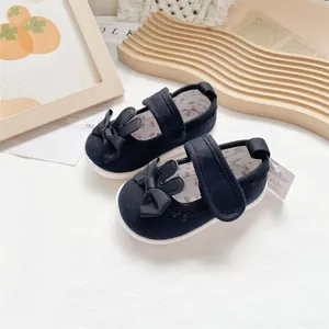 Detailed view of dark navy baby shoes with cute rabbit ears and bow decorations