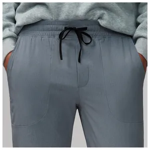 Detail view of breathable mesh fabric on men's grey quick-dry running sports pants
