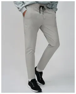 Detailed view of light grey men's quick-dry sports pants with breathable mesh texture