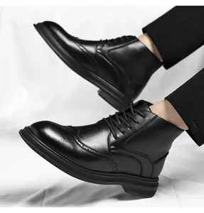 Detailed side view of men's black leather brogue boots with intricate carvings.