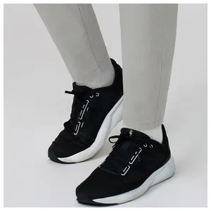 Detail shot of grey breathable quick-dry sports pants for men on model legs.