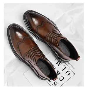 High-angle view of brown leather men's brogue boots featuring intricate carved details