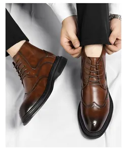 Detail of men's brown brogue Martin boots with intricate wingtip carving details.