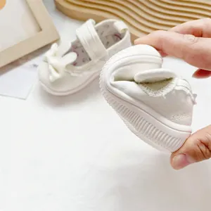 Detailed view of white toddler girl walker shoe demonstrating flexible soft rubber sole