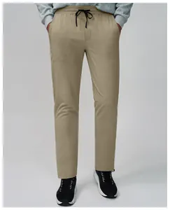 Close-up of breathable quick-dry men's fitness joggers in khaki with adjustable drawstring