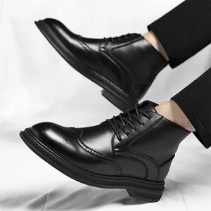 Elegant men's black brogue boots with intricate carving and lace-up design