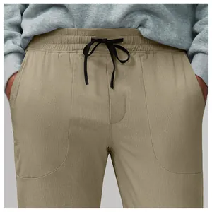 Close-up of khaki breathable mesh athletic joggers with black drawstring and side pockets