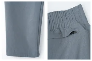 Detail of breathable mesh fabric and zipper pocket on quick-dry men's sports pants