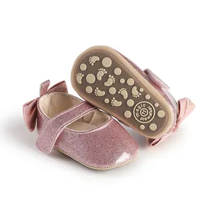 Detail view of pink glitter baby pre-walker shoes with non-slip patterned soft soles