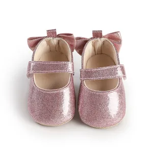 Sparkly pink glitter baby girl walk-assisting shoes with a cute bow detail on the heel.