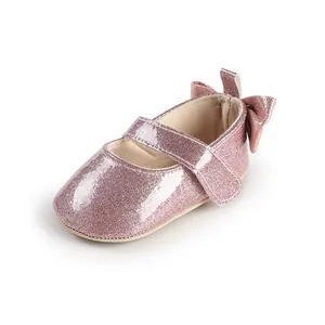 Detailed view of sparkly pink baby girl Mary Jane shoes featuring a cute heel bow.