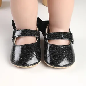 Detailed view of black glitter baby girl shoes with cute back bow design