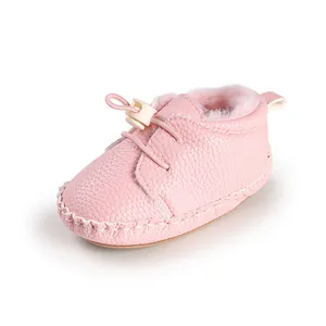 Nahaufnahme eines rosafarbenen Babyschuhs mit Plüschfutter und elastischem Verschluss