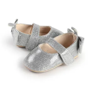 Detailed view of silver glitter baby girl pre-walker shoes featuring cute bow and strap.