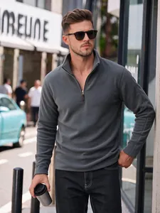 Modern men's grey polar fleece half-zip sweatshirt shown on a model in a city street scene