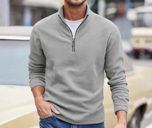 Detailed view of a men's grey half-zip fleece sweatshirt featuring a soft stand collar design
