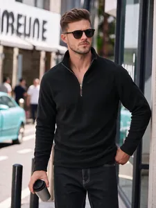 Close-up of a stylish man wearing a premium black half-zip fleece stand collar sweatshirt