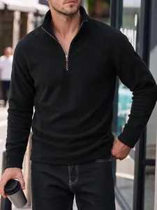 Detailed view of men's black polar fleece half-zip sweatshirt with stand-up collar