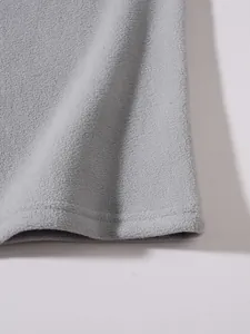 High-quality macro detail showing the soft texture of gray polar fleece fabric and hem