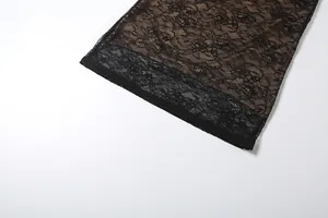 Detailed close-up showing the intricate floral black lace pattern and hemline on this sexy dress