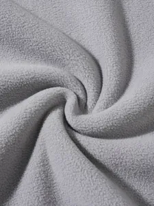Macro detail of grey polar fleece fabric showing soft texture and warm swirl