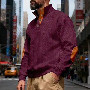 Detailansicht eines weinroten Jacquard-Sweatshirts mit orangefarbenen Ellbogen-Patches
