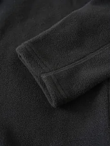 Close-up detail of soft black fleece jacket sleeve cuff showing high-quality stitching
