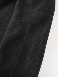 Macro view showing the soft texture and stitching of black polar fleece fabrics.