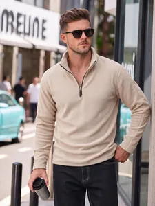 Detailed view of a men's beige half-zip polar fleece pullover with a stand collar