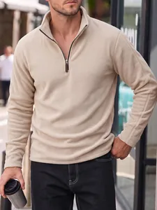 Detailed view of men's beige polar fleece half-zip sweatshirt featuring a stand collar design