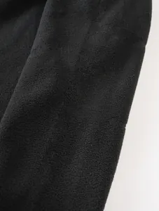 Macro view of the soft black polar fleece fabric texture on this premium men's sweatshirt