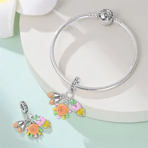 Detailed close-up of travel-themed silver charms featuring vibrant enamel beach designs