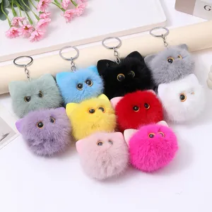 Colorful collection of cute fluffy cat head plush keychains in various soft colors.