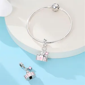Detailed close-up of pink castle charm with enamel on a silver-plated snake bracelet