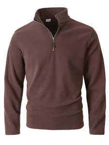 Detail view of men's brown polar fleece half-zip sweatshirt with stand collar.