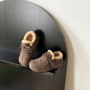 Close-up of children's brown suede shoes with warm faux shearling lining