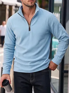 Detail view of a men's light blue polar fleece sweatshirt with half-zipper and stand collar