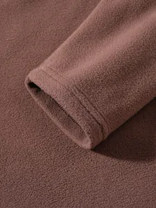 Macro detail of soft brown polar fleece sweatshirt sleeve cuff with neat stitching