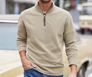 Close-up of men's khaki polar fleece sweatshirt with half-zip and stand collar details
